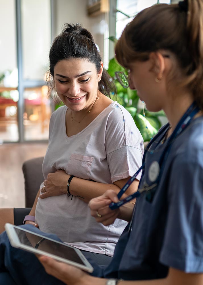 pregnant woman meeting with her doctor